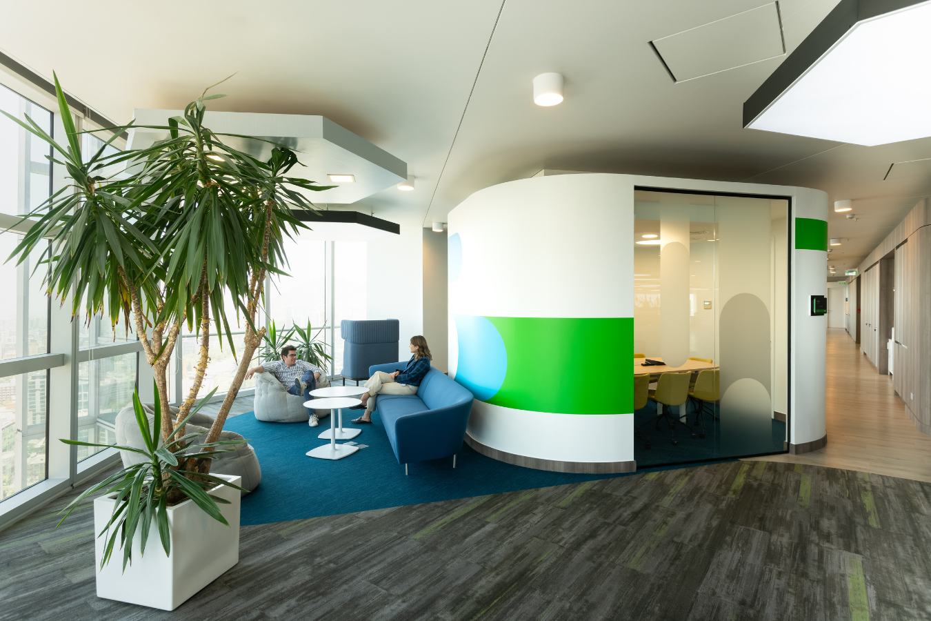 Checkr Offices - Semi-private collaboration zone with curved walls and vibrant green accents - Contract Workplaces.jpg